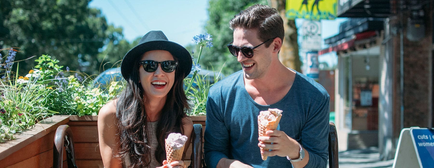 man and woman eating ice cream outside on a sunny day
